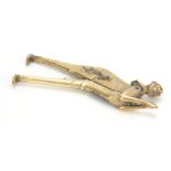 A 19TH CENTURY BRASS FIGURAL BETEL NUT CUTTER with engraved decoration 21cm long 7cm wide