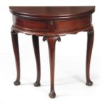 AN EARLY GEORGE III MAHOGANY DEMI LUME SHAPED TILT TOP TEA TABLE the double-hinged top revealing a