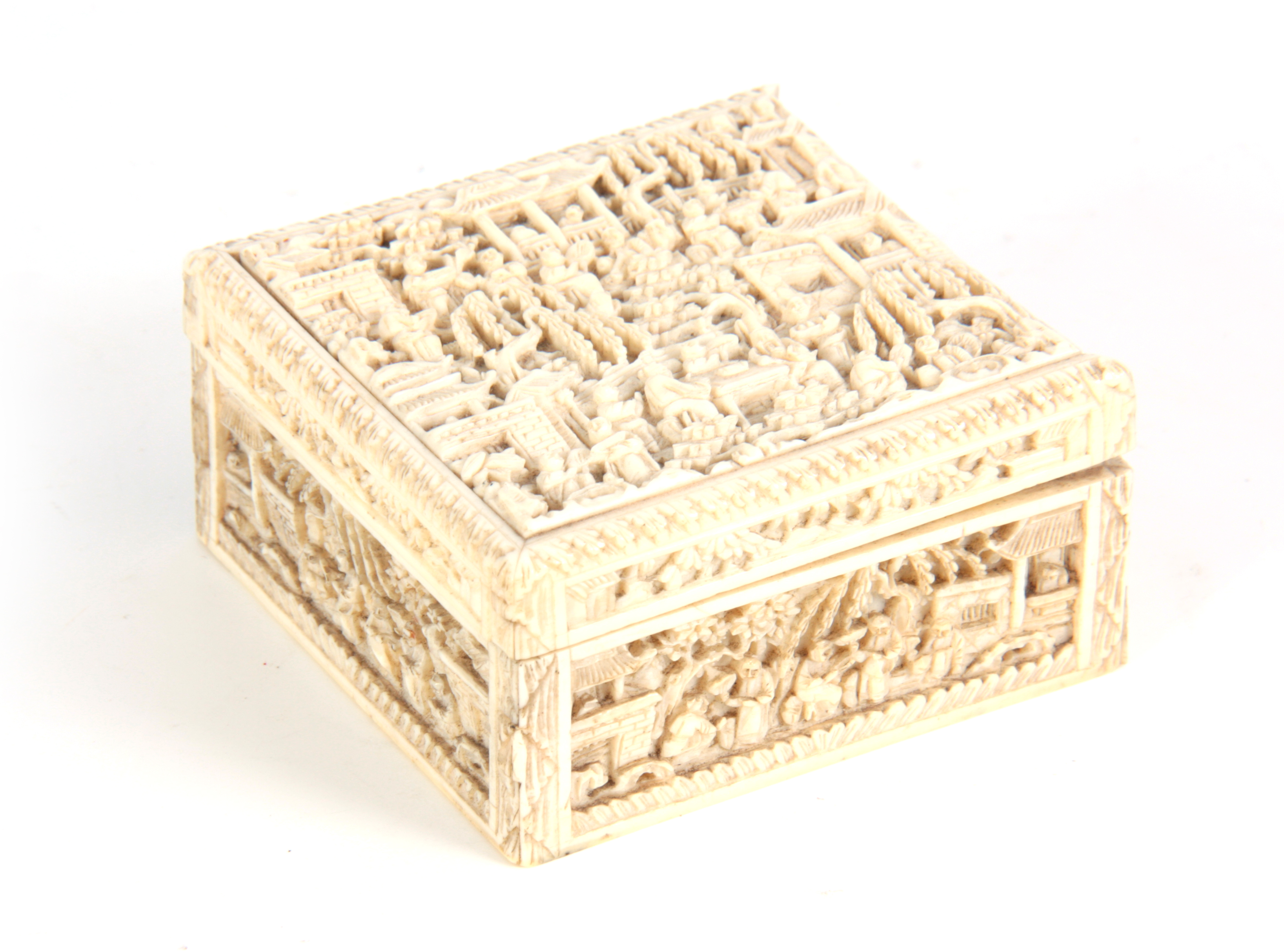 A 19TH CENTURY CHINESE CANTON CARVED IVORY LIDDED BOX finely decorated with figures seated under