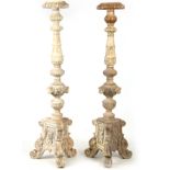 A LARGE PAIR OF CONTINENTAL CARVED PAINTED TORCHERES having acanthus leaf and gadrooned stems with