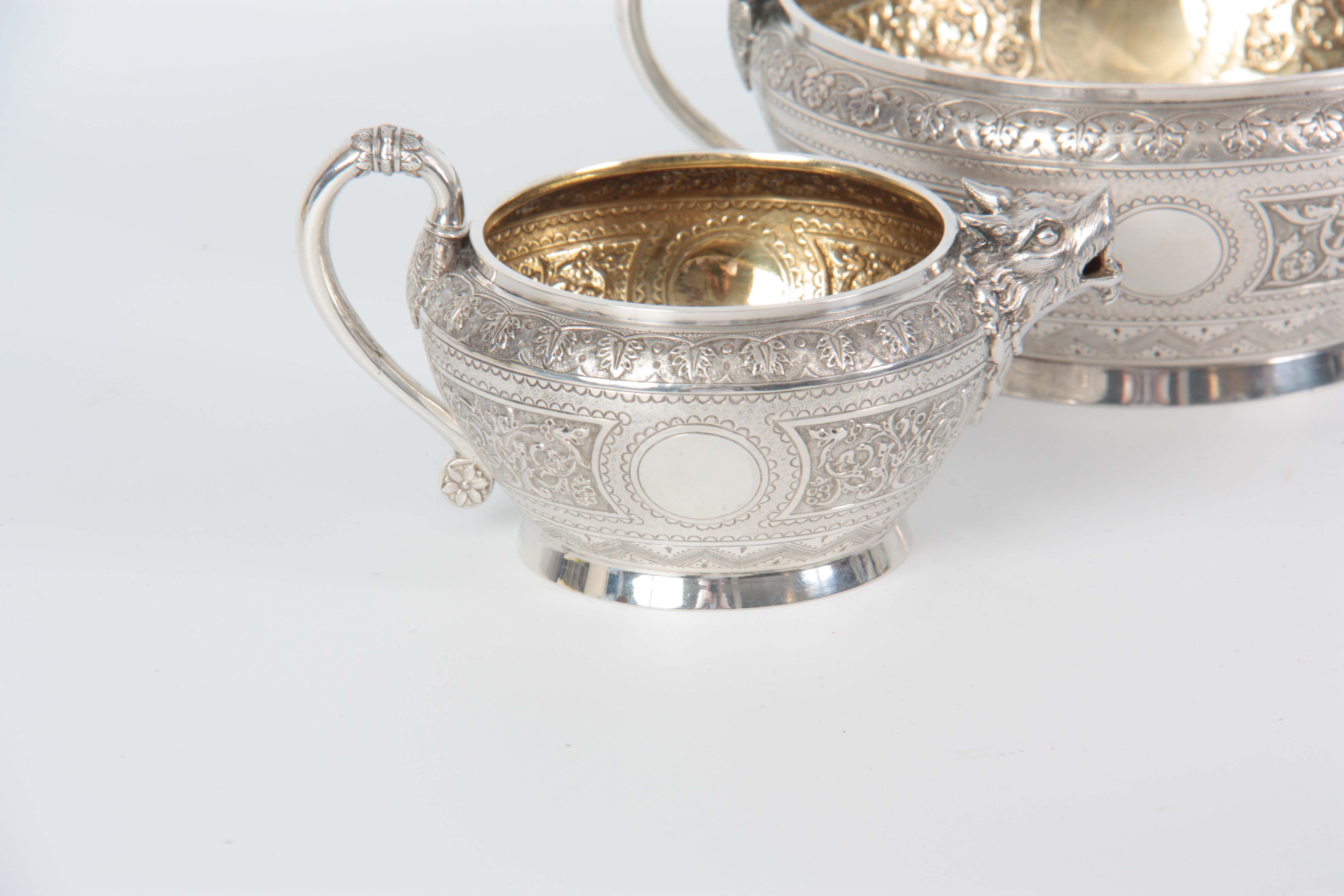 A VICTORIAN SILVER AND GILT CREAM JUG AND SUGAR BOWL having relief scroll-work panels and fine - Image 3 of 7