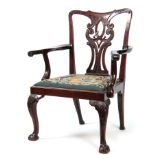 A GEORGE III CHIPPENDALE STYLE MAHOGANY OPEN ARMCHAIR with scrolled, leaf carved, pierced back splat