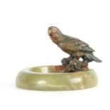 A LATE 19TH CENTURY COLD PAINTED BRONZE SCULPTURE of a perched Parakatte on the rim of a circular