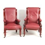 A PAIR OF LATE 19TH CENTURY MAHOGANY RED LEATHERED ARMCHAIRS with shaped backs and open arms