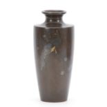 A JAPANESE MEIJI PERIOD BRONZE AND INLAID MIXED METAL TAPERING VASE depicting a peacock sat in