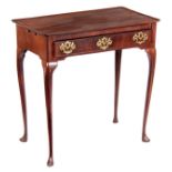 A GEORGE II FIGURED MAHOGANY SIDE TABLE with dished top, side candle slides, fitted frieze drawer