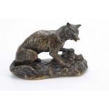 A LATE 19th CENTURY PATINATED BRONZE SCULPTURE modelled as a fox with a pheasant on a naturalistic