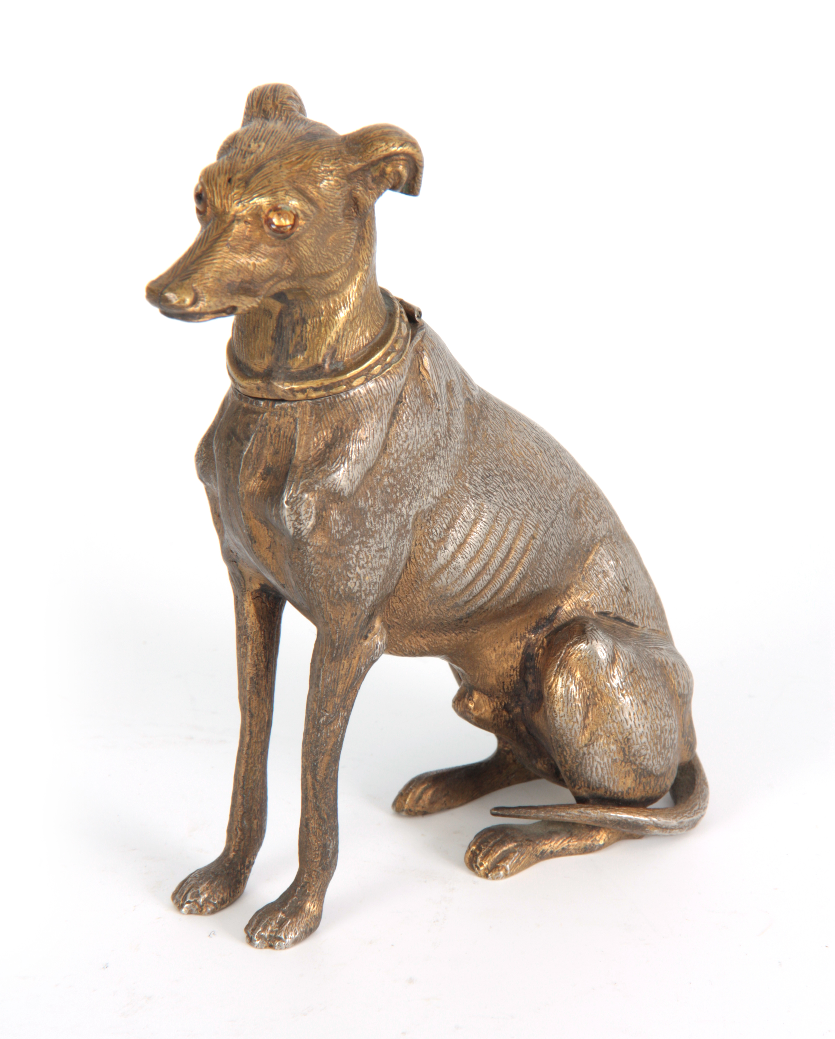 A LATE 19th CENTURY NOVELTY INKWELL modelled as a gilt metal greyhound with amber glass eyes