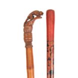 TWO EASTERN WALKING CANES one handle carved with a gecko on a bamboo shaft 89cm long, the other