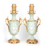 A STYLISH PAIR OF LATE 19TH CENTURY FRENCH CELADON GLAZED PATE SUR PATE AND ORMOLU MOUNTED OIL LAMPS