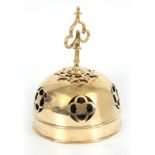 A LATE 19TH CENTURY BRASS DOMED BELL with gothic pierced panels and four small multi-toned bells