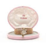 A LADIES 9CT GOLD TUDOR ROLEX WRIST WATCH on 9ct gold bracelet, the silvered dial with gold baton