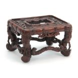 A SMALL CHINESE HARDWOOD STAND having carved simulated bamboo decoration with cabriole style legs