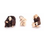 A COLLECTION OF THREE EARLY 20th CENTURY IVORY AND HARDWOOD NETSUKE sculptured as various figures