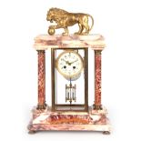 AN EARLY 20th CENTURY FRENCH MARBLE AND ORMOLU FOUR-GLASS MANTEL CLOCK the case surmounted by a gilt