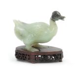 A CHINESE CARVED SCULPTURE OF A DUCK mounted on a pierced hardwood base 14cm wide 11cm high.