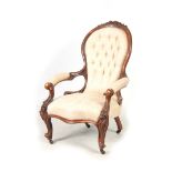 A VICTORIAN GENTLEMANS CARVED WALNUT BUTTON BACKED DRAWING ROOM CHAIR with carved frame and open