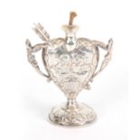 A LATE 19th CENTURY SILVER HEART SHAPED OIL LAMP with relief winged cherub heads and fairy handles