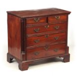 A GEORGE III MAHOGANY LANCASHIRE CHEST OF DRAWERS with quarter column sides flanking two small and