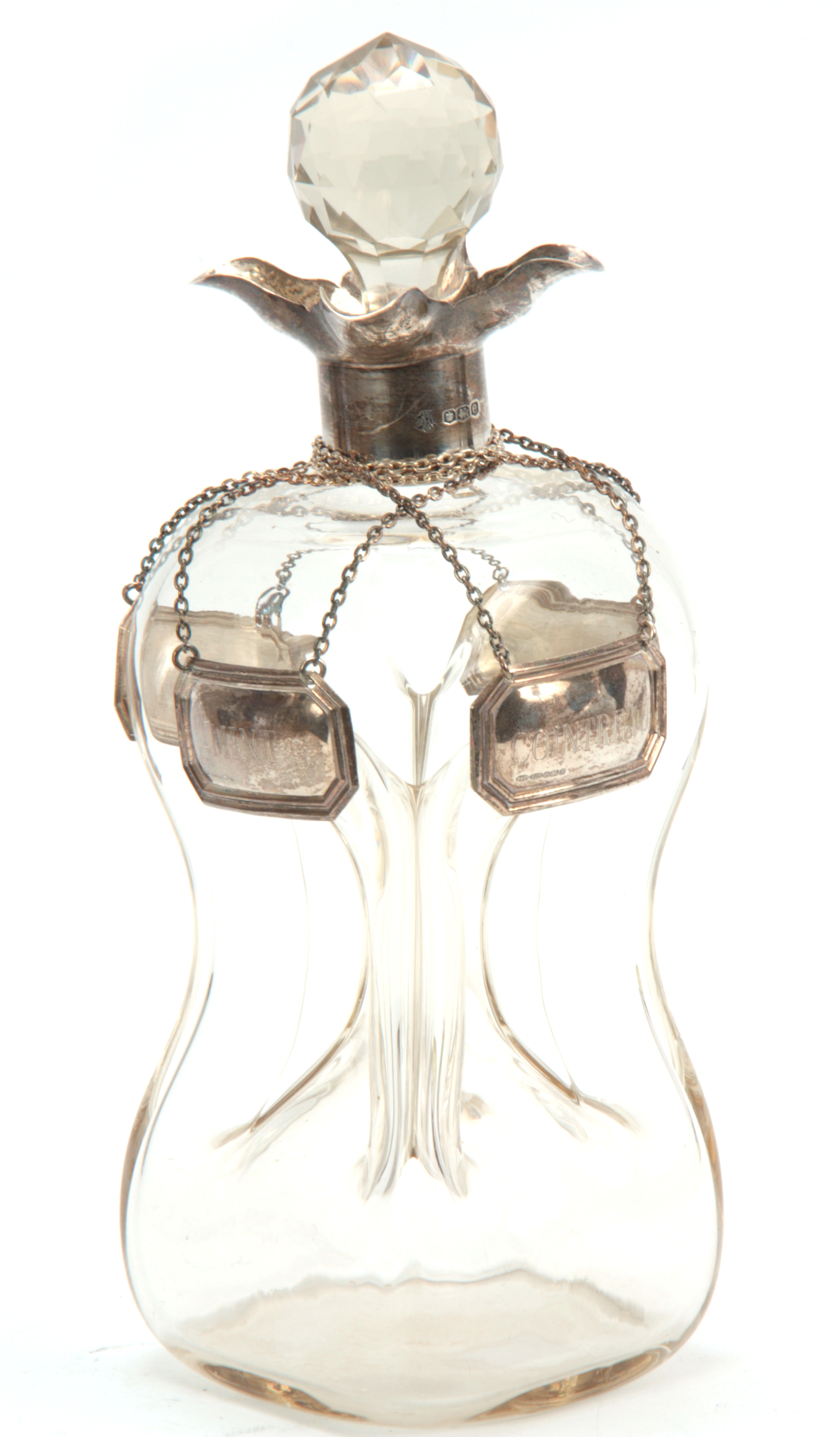 A GEORGE V SILVER MOUNTED SPIRIT DECANTER AND STOPPER with quatrefoil pouring lips and pinched clear