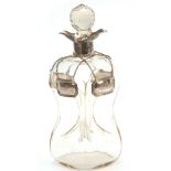 A GEORGE V SILVER MOUNTED SPIRIT DECANTER AND STOPPER with quatrefoil pouring lips and pinched clear