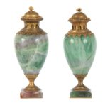 A PAIR OF LATE 19TH CENTURY FRENCH ORMOLU MOUNTED GREEN FELDSPAR LIDDED URNS having colourful veined