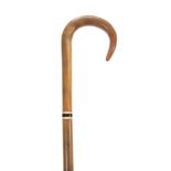 A LATE 19TH / EARLY 20TH CENTURY POSSIBLY RHINO HORN WALKING STICK with curved handle and with