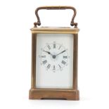 A LATE 19TH CENTURY FRENCH BRASS STRIKING CARRIAGE CLOCK the corniche case with enamel dial and