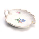 A 19TH CENTURY MEISSEN LEAF SHAPED DISH decorated with painted flowers, having a branch work