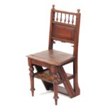 A 19TH CENTURY OAK LIBRARY STEPS / CHAIR with panelled back and turned front legs.