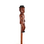 A 19TH CENTURY FOLK ART WALKING CANE carved with a man wearing a top hat 102cm overall.