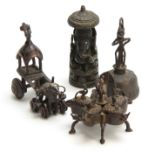 A GROUP OF FOUR EASTERN CAST BRONZE TEMPLE TOYS depicting elephants, peacocks and a bell 13.5cm high