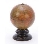 AN EARLY 19th CENTURY 3" MINIATURE TERRESTRIAL GLOBE STRING DISPENSER on turned ebonised circular