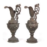 A PAIR OF LATE 19TH CENTURY CONTINENTAL COPPERED METAL EWERS each of ornate design with embossed