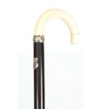 A 19TH CENTURY IVORY AND ROSEWOOD WALKING CANE with shaped handle and silver hall-marked collar