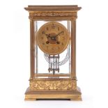 A LATE 19th CENTURY FRENCH GILT BRASS FOUR-GLASS MANTEL CLOCK the case with applied scroll-work,