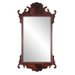 A 20TH CENTURY MAHOGANY FRET-CUT HANGING MIRROR having a rectangular mirror plate surrounded by a