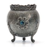 AN EARLY 20TH CENTURY WHITE METAL VASE decorated with Ruskin jewels having planished finish with