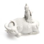 A CHINESE BLANC DE CHINE FIGURE of a seated water buffalo with a young man seated on top 18cm wide