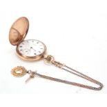 A 9CT GOLD FULL HUNTER WALTHAM POCKET WATCH WITH 9CT GOLD FOB the spring-loaded hinged cover opening
