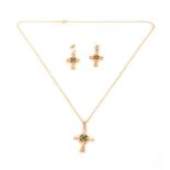 A 9CT GOLD AND EMERALD PENDANT AND CHAIN with matching earrings modelled as the Celtic Cross app.