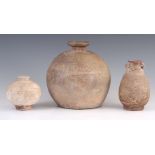 THREE ANTIQUE CHINESE UNGLAZED STONEWARE VASES one of spherical shape 20cm, another ovoid with two