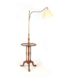 AN EDWARDIAN MAHOGANY ELECTRIFIED READING TABLE / OCCASIONAL TABLE with a brass adjustable stem