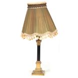 A BRASS CORINTHIAN COLUMN ELECTRIFIED TABLE LAMP with reeded ebonized stem ad green pleated green