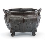 A 18/19th CENTURY CHINESE OXTAGANOL PATINATED BRONZE JARDINIERE having a panelled body with raised