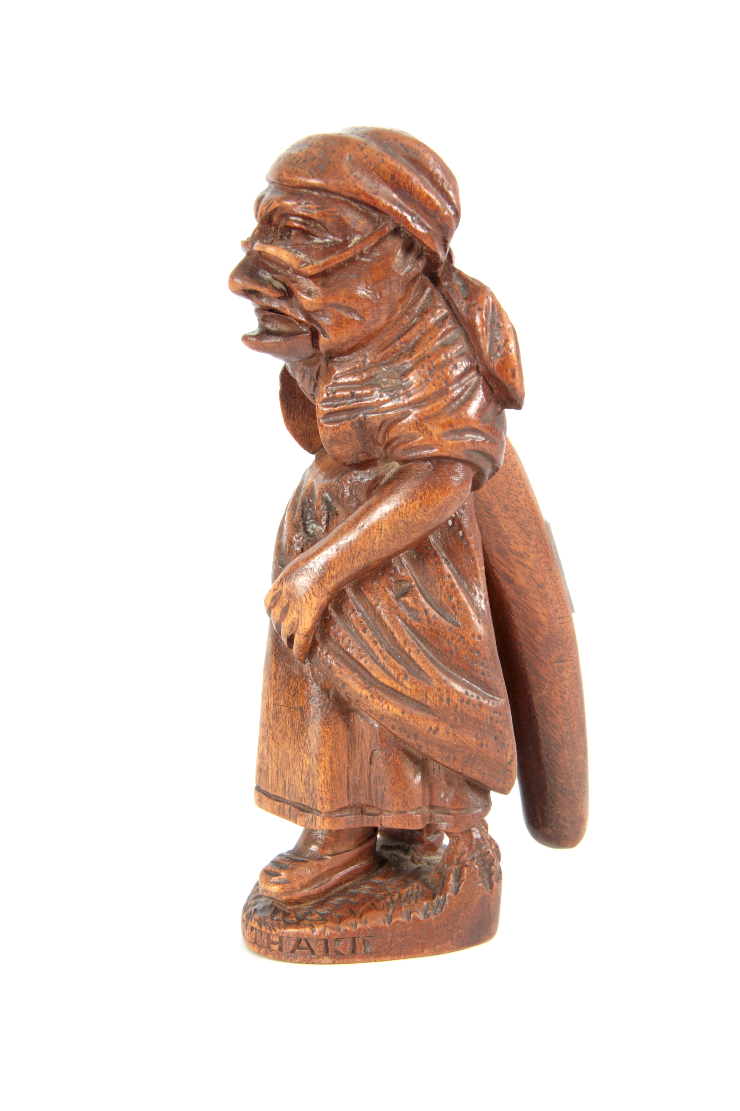 A LATE 19TH CENTURY SWISS BLACK FOREST NUTCRACKER formed as an old woman with headscarf and glasses,