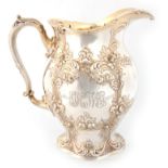 AN AMERICAN ART NOUVEAU SILVER GILT WATER JUG having embossed foliate scrollwork decoration 23cm