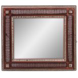 AN EARLY 20TH CENTURY LIBERTY STYLE MAHOGANY MOORISH INLAID AND TURNED FRAMED MIRROR decorated