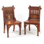 A PAIR OF LATE 19TH CENTURY AESTHETIC PERIOD GOTHIC REVIVAL PITCH PINE HALL CHAIRS IN THE MANER OF