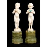 FERDINAND PREISS (1882-1943). AN EARLY 20TH CENTURY PAIR OF SMALL IVORY SCULPTURES OF YOUNG BOYS